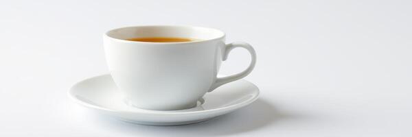 Warm cup of tea on a simplistic white surface during a calm afternoon photo