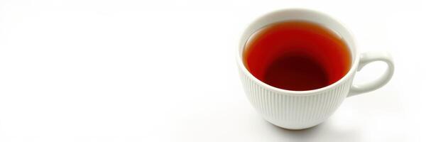 Warm cup of tea sitting on a white surface with a focused view during a calm morning photo