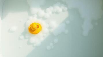 Bright yellow rubber duck floats among bubbles in a bath setting during a relaxing evening photo