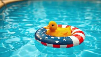 Bright yellow duck with American flag float in blue swimming pool water during sunny day photo
