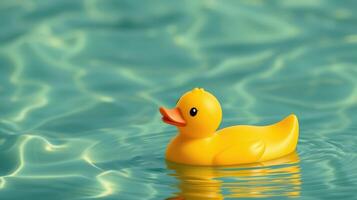 Bright yellow rubber duck floats peacefully on shimmering water surface during sunny day at local pool photo