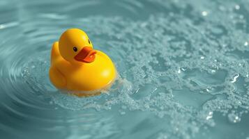 Rubber duck floats serenely in clear water creating gentle ripples during a bright, sunny day photo