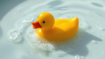 Bright yellow rubber duck floats in soapy water, creating a cheerful ambiance in a bathroom setting photo