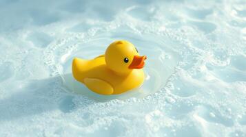 Bright yellow rubber duck floats on surface of foamy water creating a playful atmosphere photo