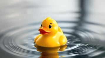 Bright yellow rubber duck floats serenely on calm water creating ripples in peaceful surroundings photo