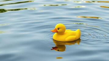 Floating yellow rubber duck on calm water in a serene outdoor setting during daytime photo
