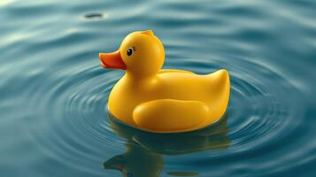 Yellow rubber duck floating on calm water with gentle ripples in a serene setting photo