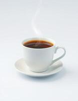 Hot coffee served in a white ceramic cup with a delicate saucer, steam rising in a minimalist setting photo