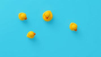 Colorful yellow rubber ducks floating playfully on a bright blue background creating a cheerful and whimsical atmosphere photo
