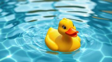 Yellow rubber duck floating calmly on water surface in a bright blue pool during sunny day photo