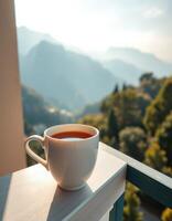 Sipping coffee on a balcony with beautiful mountain views during sunrise photo
