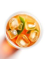 Refreshing iced tea with mint leaves and ice cubes served in a clear cup for a cooling summer drink photo