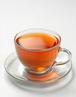 Warm cup of herbal tea presented in a clear glass cup on a minimalist background enjoying a cozy moment photo