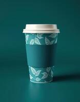 Stylish disposable coffee cup with leaf designs on teal background, showcasing modern eco-friendly branding concepts photo
