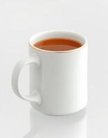 Warm cup of tea on a minimalist table showcasing simple elegance and tranquility in an indoor setting photo