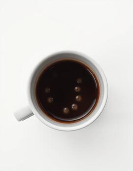 Enjoying a rich cup of dark coffee with bubbles on the surface in a minimalist setting photo
