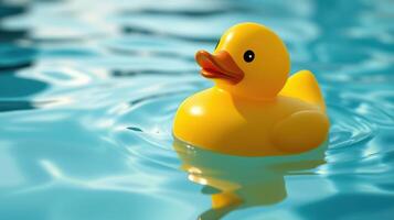 Floating yellow rubber duck on calm water in a sunny setting with gentle ripples photo