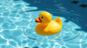 Bright yellow rubber duck floats gently in a sparkling blue pool under warm sunlight photo
