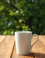 White mug on a wooden table in a green garden during morning light photo