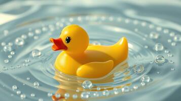 Bright yellow rubber duck floating gently on the water surface surrounded by small bubbles photo