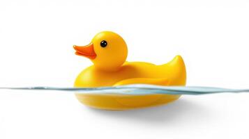 Rubber duck floats on water, showcasing bright yellow color in a serene setting with clear blue tones photo