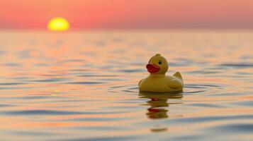 Floating yellow rubber duck at sunset over tranquil water photo