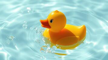 Bright yellow rubber duck floats in clear water creating gentle ripples and bubbles during a sunny afternoon playtime photo