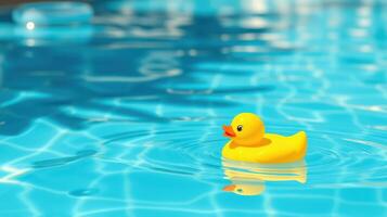 Bright yellow rubber duck floating on sparkling blue water under sunlight on a warm afternoon photo