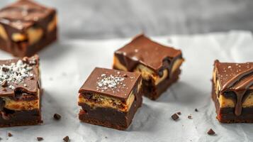 Delicious chocolate and peanut butter brownies with creamy layers served on parchment paper photo