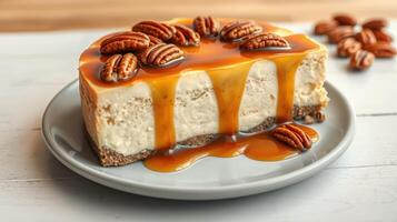 Delicious pecan caramel cheesecake served on a grey plate with nuts on the side photo