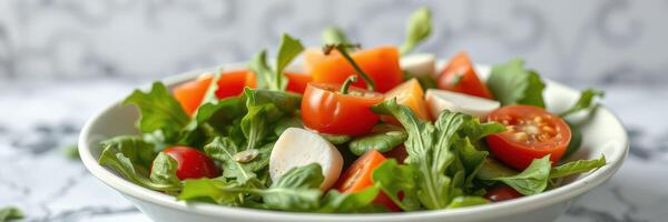 Fresh mixed salad featuring cherry tomatoes and leafy greens in a bowl on a patterned tablecloth photo