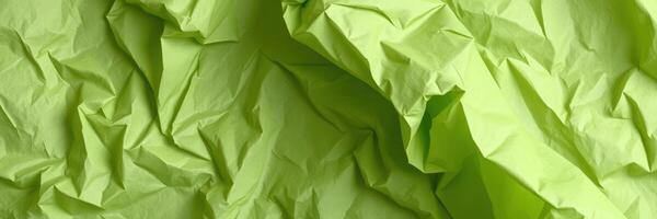 Wrinkled green paper creating abstract textures suitable for artistic backgrounds and craft projects photo