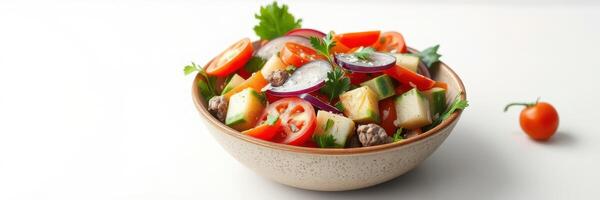 Colorful salad with fresh vegetables and herbs in a bowl on a clean white surface photo