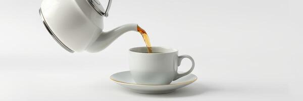 Pouring warm tea from a teapot into an elegant white cup on a minimalistic surface photo