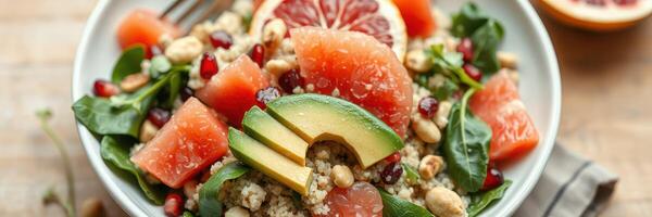 Colorful salad with spinach, quinoa, and fresh fruits served in a bowl photo
