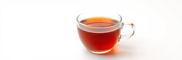 Clear glass cup filled with steaming hot tea on a plain white background during afternoon hours photo