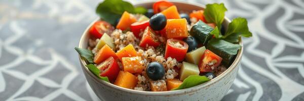 Fresh fruit and grain salad served in a bowl on a patterned tablecloth in a bright environment photo