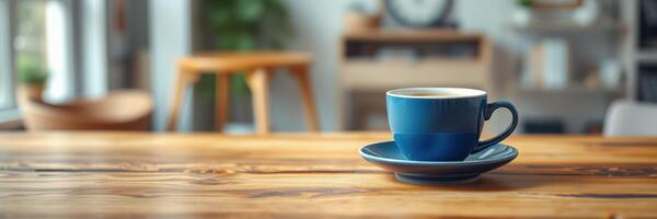 Coffee cup rests on a wooden table in a cozy cafe, sunlight filtering through the window photo