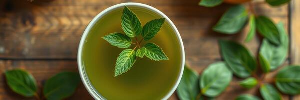 Fresh mint leaves garnish a warm cup of herbal tea on rustic wooden table photo