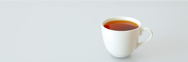 Warm cup of tea placed on a minimalistic white table during a calm afternoon photo