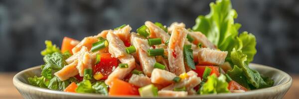 Fresh salad with sliced chicken, colorful vegetables, and vibrant greens served in a bowl at a dining table photo