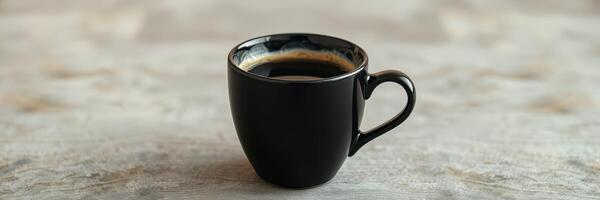 Black coffee served in a small cup on a minimalist stone surface during morning light photo