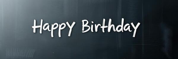 Happy Birthday greeting written in chalk on a blackboard for celebration of a special day photo