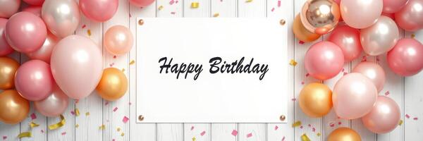 Colorful birthday decorations with balloons and a greeting sign on a wooden background photo