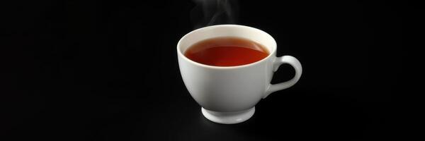 Hot steaming cup of tea placed on a dark surface exuding warmth and comfort in a cozy environment photo