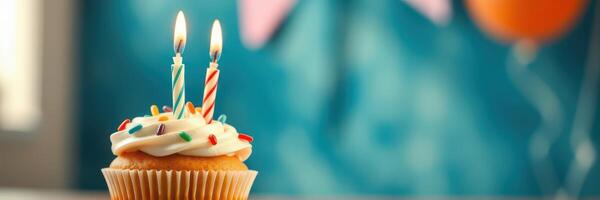 Happy birthday celebration featuring a colorful cupcake with candles and festive decorations in the background photo