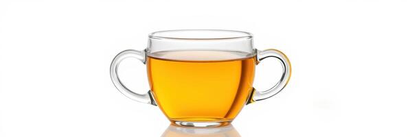 Clear glass cup filled with golden tea reflecting sunlight on a white surface photo