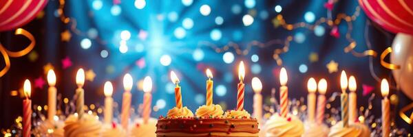 Birthday celebration with a lit cake surrounded by colorful decorations in a festive atmosphere photo