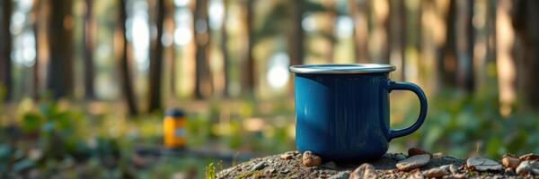 Coffee mug resting on a stone surrounded by lush forest foliage in a peaceful outdoor setting photo