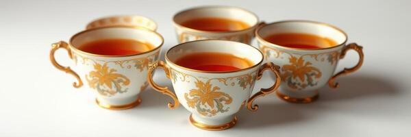 Elegant tea cups arranged on a white surface showcasing fine china craftsmanship and delicate design details photo